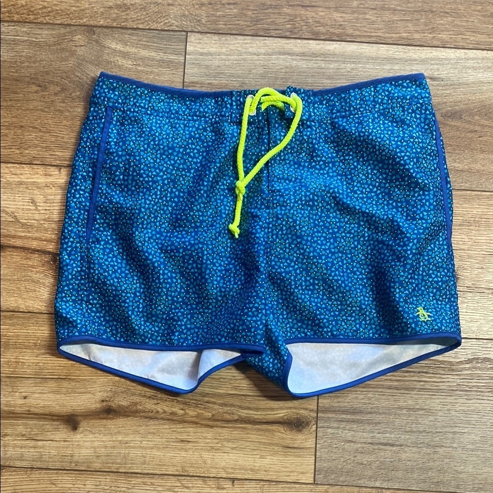 Original Penguin swim trunks with a pattern of small, dark blue dots